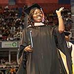 Graduate smiling and waving