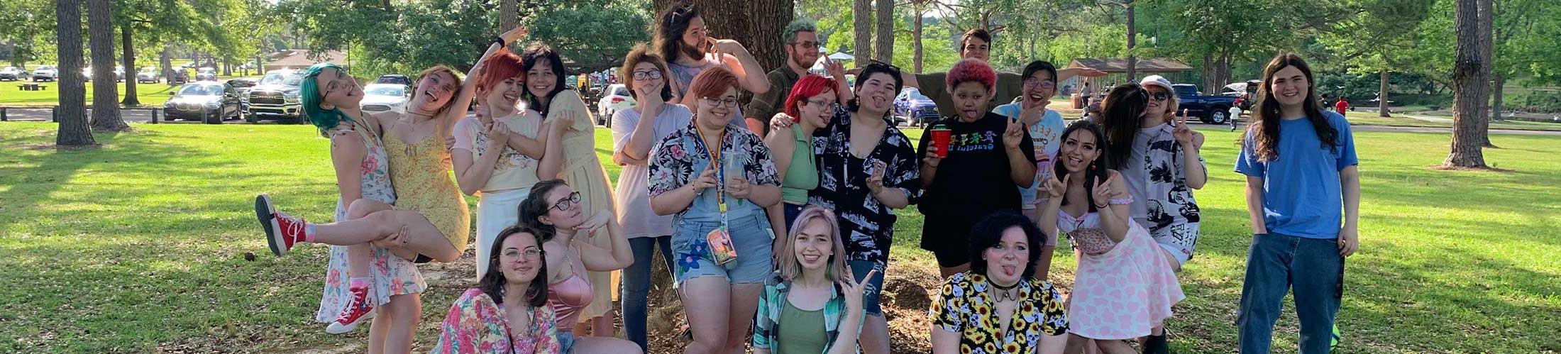 Group of Spectrum students outside in front of a tree on campus.